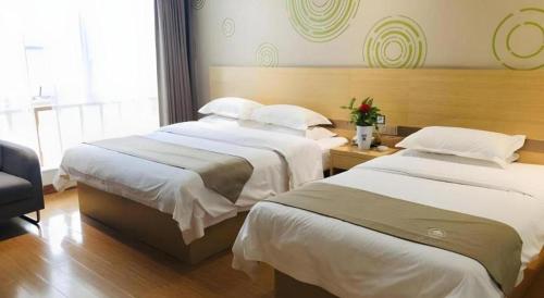 Ένα ή περισσότερα κρεβάτια σε δωμάτιο στο GreenTree Inn Heze Danxian Shangmaocheng Business Branch