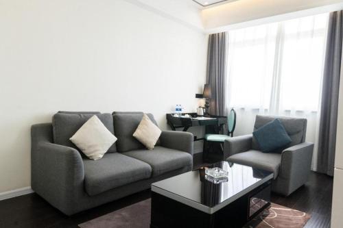 a living room with a couch and two chairs at Xana Hotelle Xi'an GONG IP South Gate of Zhonglou in Xi'an