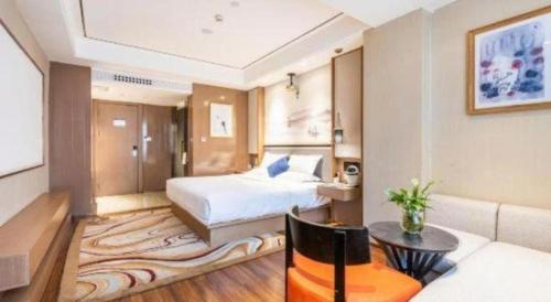 a hotel room with a bed and a couch at East Queen Hotel (Xi'an Beimen Metro Station) in Xi'an