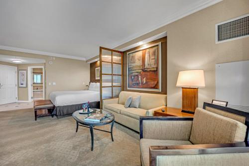 a hotel room with a bed and a living room at Sakura Serenity-View-No Resort Fee in Las Vegas