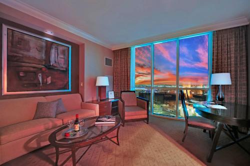 a living room with a couch and a table at Sakura Serenity-View-No Resort Fee in Las Vegas