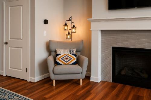 a living room with a chair and a fireplace at Spacious Downtown Sq Stadium, Casino, R&R HoF! in Cleveland