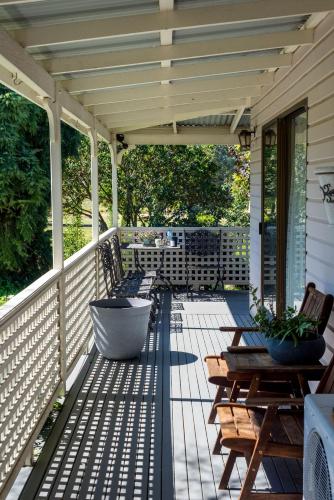 a porch with benches and tables on a house at Sabo’s On Severn in Fletcher