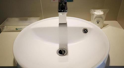 a white sink with a faucet on a counter at City Comfort Inn Lichuan Railway Station Tenglong Cave in Enshi