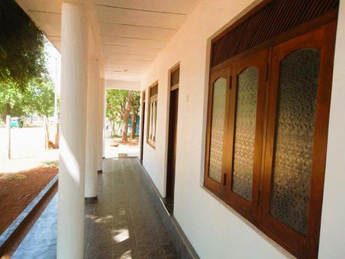 a hallway of a house with wooden doors at Lakeside Paradise in Kataragama