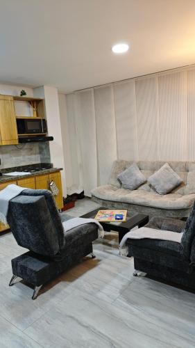 a living room with two chairs and a couch at Apartamento centro Marinilla in Marinilla