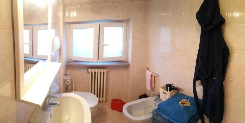 a bathroom with a sink and a toilet and a window at Villetta Punta Ala in Punta Ala