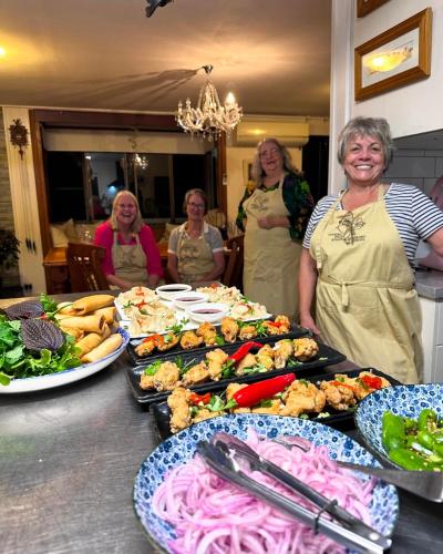 a group of women standing in front of a table of food at Sabo’s On Severn in Fletcher
