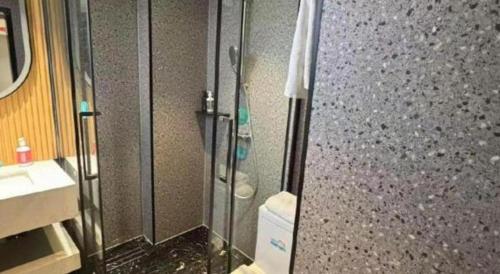 a bathroom with a shower and a toilet and a sink at City Comfort Inn Qingyuan Longtang Light Rail Changlong in Qingyuan