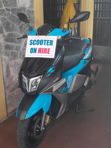 a scooter parked in a garage with a sign on it at Hotel August International in Pokhara