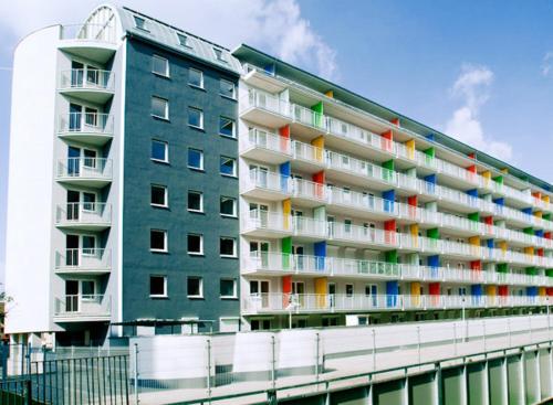 a large apartment building with colorful windows and balconies at TK Apartments Spiżowa in Wrocław