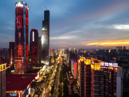 a city lit up at night with many tall buildings at Echarm Hotel Nanning the MixC Dongmeng Business District in Nanning