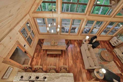 an overhead view of a living room and kitchen in a wooden house at Mountain Hideaway with Hot Tub & Fire Pit in Mineral Bluff