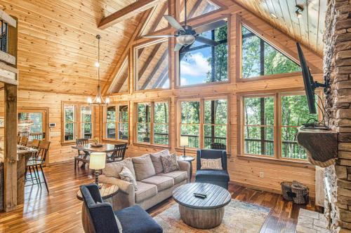 a living room with a vaulted ceiling with windows at Mountain Hideaway with Hot Tub & Fire Pit in Mineral Bluff