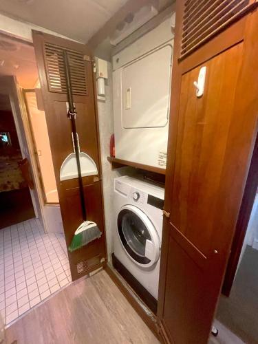 a small bathroom with a washing machine and a washer at The Great Escape - Shirley in Sooke