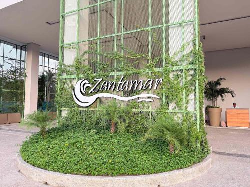 a sign on the side of a building with plants at Luxury Oceanview 2BR La Cruz de Huanacaxtle in Cruz de Huanacaxtle