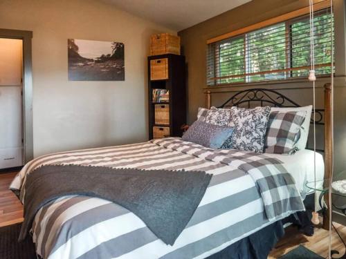 a bedroom with a bed and a window at The Great Escape - Port Renfrew in Port Renfrew
