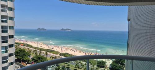 a view of the beach from the balcony of a condo at VISTA ESPETACULAR - TWIN TOWERS - Barra da Tijuca in Rio de Janeiro