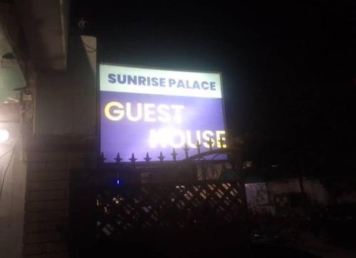 a sign that reads sunset palace guest course at Sunrise Palace Guest House in Karachi