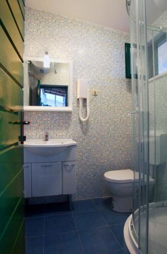 a bathroom with a sink and a toilet at Villa Sol in Vinišće