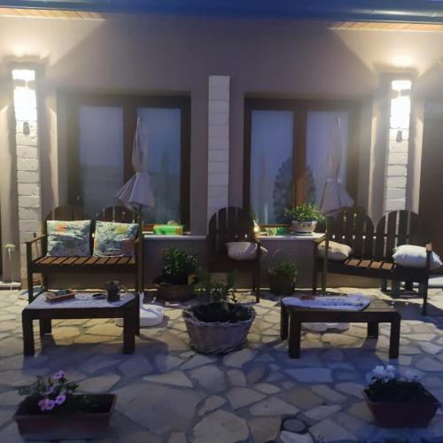 a patio with chairs and tables and potted plants at Antica Masseria Il Casone in Candela