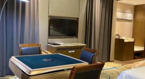 a room with a pool table in a hotel room at Venus Royal Hotel Nanning East High-Speed Railway Station in Nanning