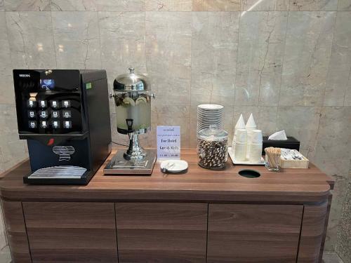 a counter with a coffee maker on top of it at Elizabeth Hotel in Bangkok