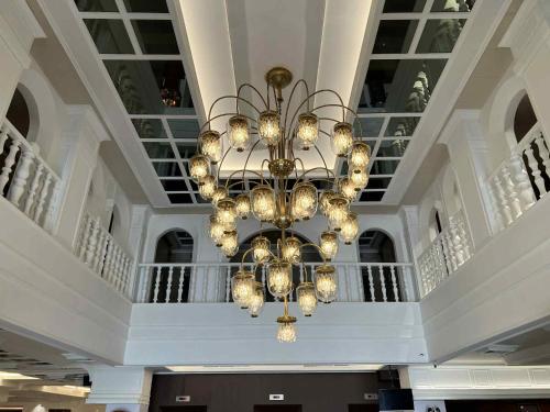 a large chandelier hanging from the ceiling of a building at Elizabeth Hotel in Bangkok