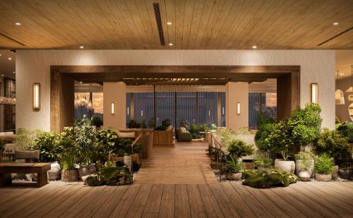 a lobby with potted plants in a building at 1 Hotel Tokyo in Tokyo