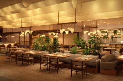 um restaurante com mesas, cadeiras e plantas em 1 Hotel Tokyo em Tóquio