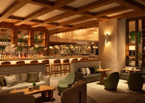 a lobby with a bar in the background at 1 Hotel Tokyo in Tokyo
