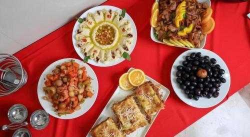 a table with plates of food on a red tray at ALAZMI HOTEL in Dubai