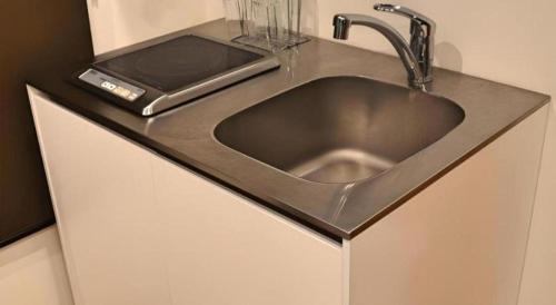 a stainless steel sink in a counter top at HOSTEL LUND I -Oimachi- in Tokyo