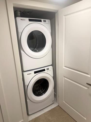 a washer and dryer in a small room next to a door at LuxSpaces Ventures in London