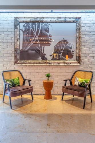 a living room with two chairs and a mirror at The Croke Park Hotel in Dublin