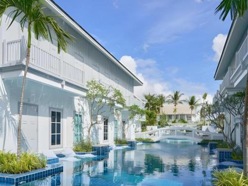 a swimming pool in the courtyard of a building at My BanLao Hotel in Luang Prabang