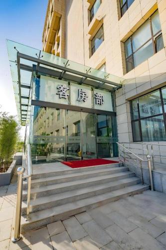 a building with a staircase in front of a building at Borrman Hotel Changzhi Medical College Wulong Campus High-speed Railway South Station in Changzhi