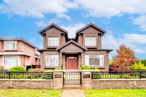 a house with a fence in front of it at Cozy two beds lower level suite in Vancouver West in Vancouver