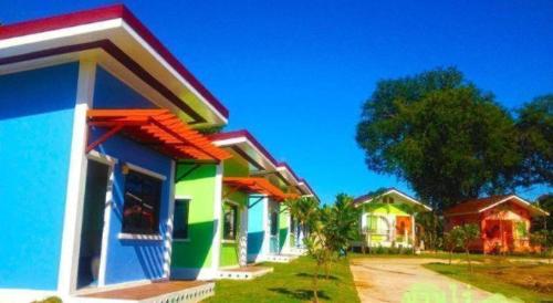 a row of colorful houses on a street at BanRai ChernMa Resort in Tak