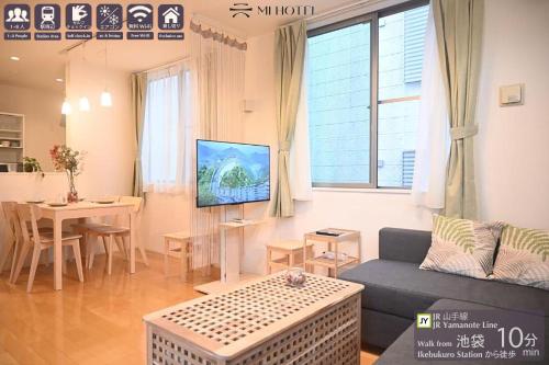 a living room with a couch and a table at Mi-Villa Pure Gray in Tokyo
