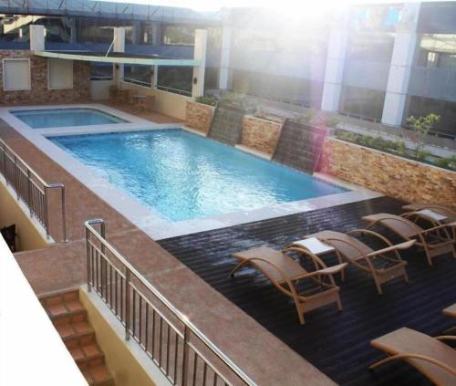 a swimming pool on top of a building at MO2 Westown Hotel San Juan in Bacolod