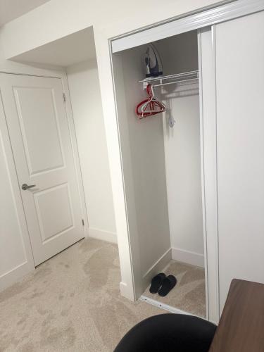 a closet with a glass door and a pair of shoes at LuxSpaces Ventures in London