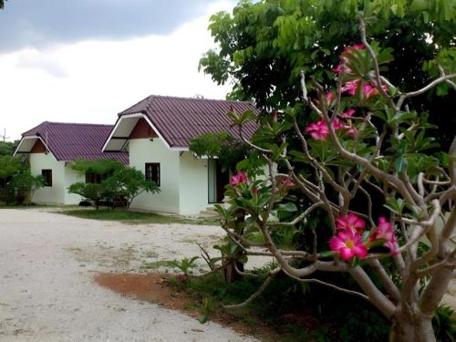 a house with pink flowers in front of it at Suanlamyai Resort in Loei