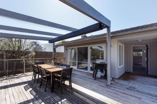 a patio with a table and chairs on a deck at Melrose Nest - Peaceful Mount Martha Stay near Beach in Mount Martha