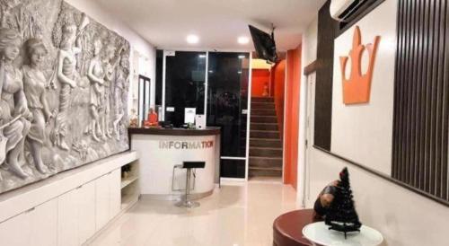 a room with a bar with a statue on the wall at The Loom Rangsit in Pathum Thani
