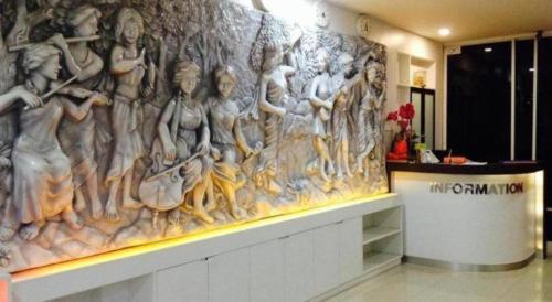 a wall with a painting of women in a building at The Loom Rangsit in Pathum Thani