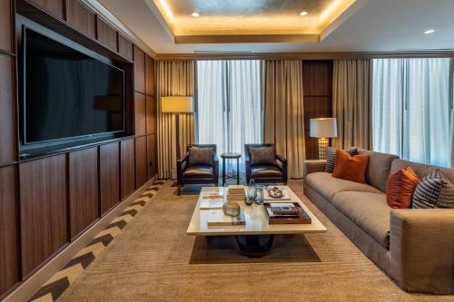 a living room with a couch and a flat screen tv at Omni Oklahoma City Hotel in Oklahoma City