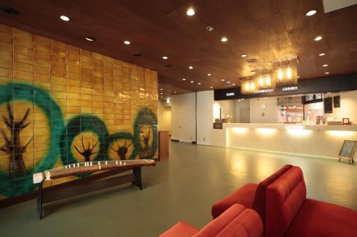 a lobby with two red couches in a room at Oka Hotel in Kanazawa