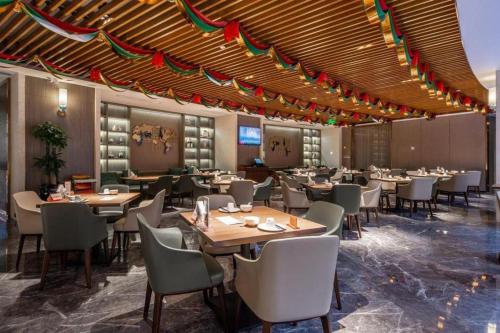 a dining room with tables and chairs and flags at Rosedale Hotel Taicang in Taicang