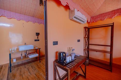 a room with a room with a table and a mirror at Ratan Villas Sariska in Alwar